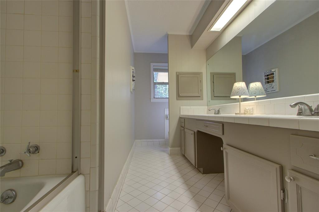 4207 Hazel Street Texarkana, TX 75503 - Photo 14 of 30 a bathroom with a sink and a bathtub