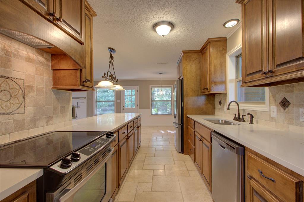 4207 Hazel Street Texarkana, TX 75503 - Photo 9 of 30 a kitchen with stainless steel appliances a sink stove and cabinets