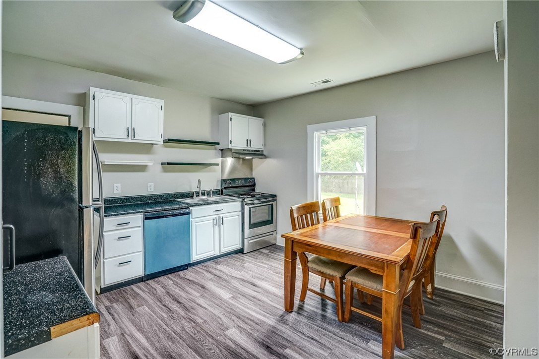 4306 Britannia Road Richmond, VA 23234 - Photo 7 of 20 a kitchen with granite countertop a stove a sink dishwasher a refrigerator with wooden floor and cabinets
