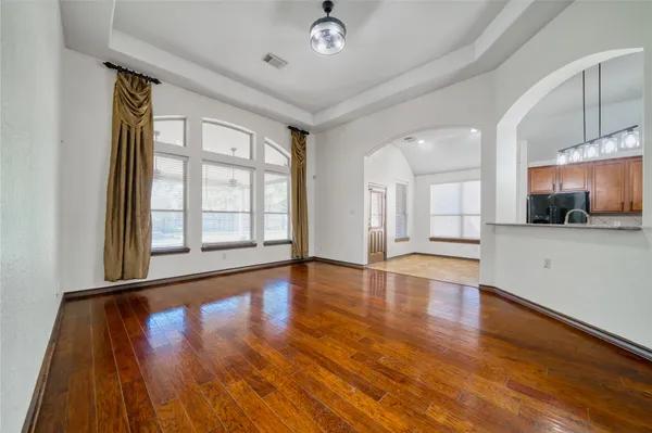 an empty room with fan and entrance