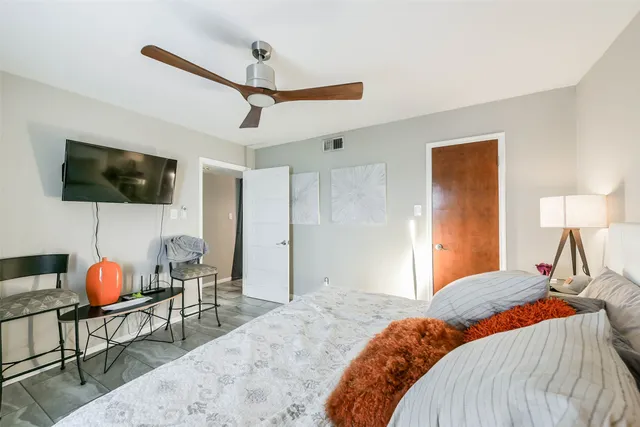 a bedroom with a bed and a flat screen tv