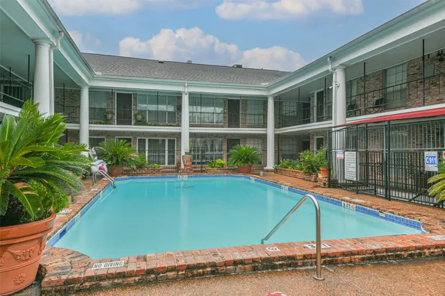 a view of a swimming pool with a yard