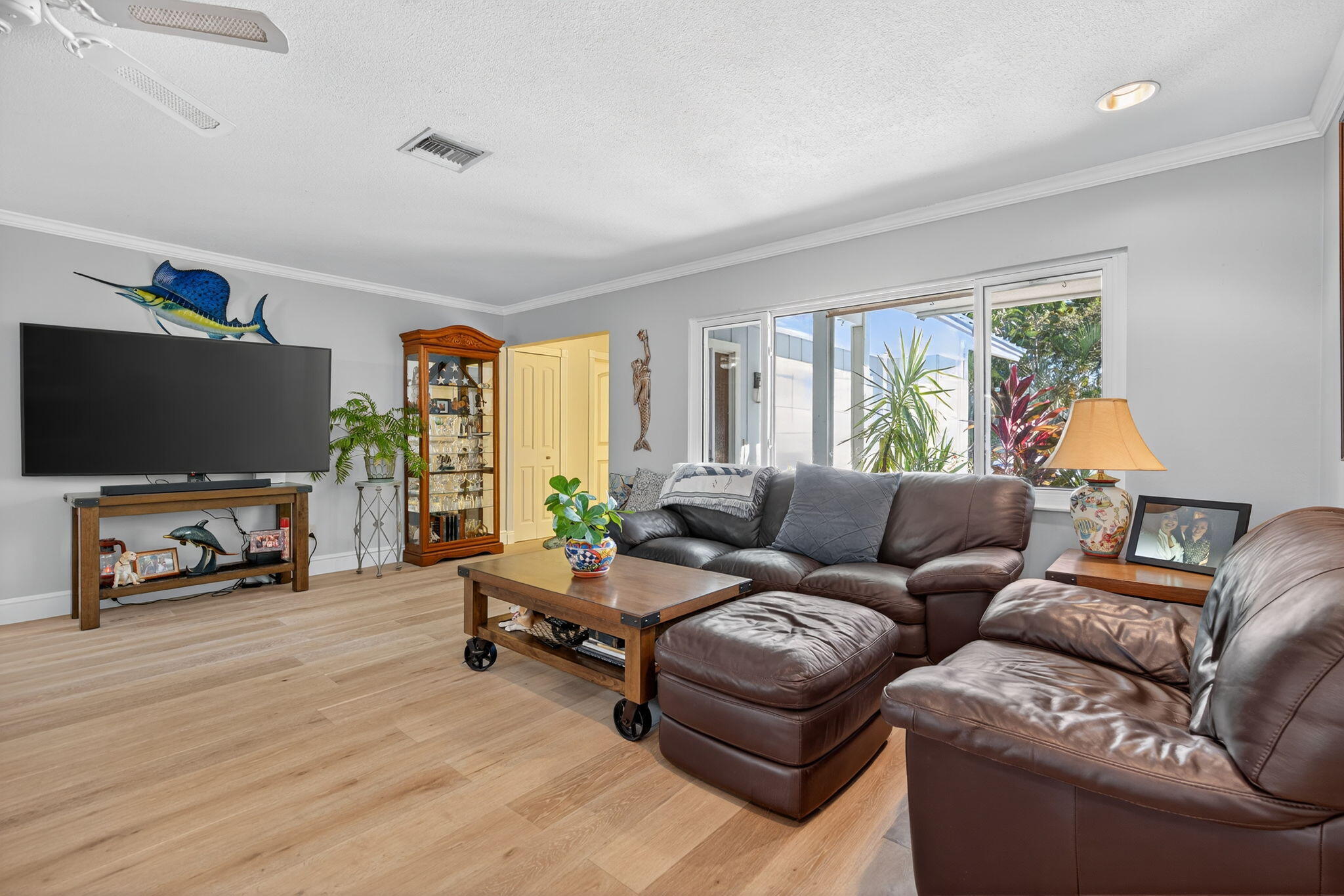 5095 Southeast Manatee Terrace Stuart, FL 34997 - Photo 12 of 58 a living room with furniture and a flat screen tv