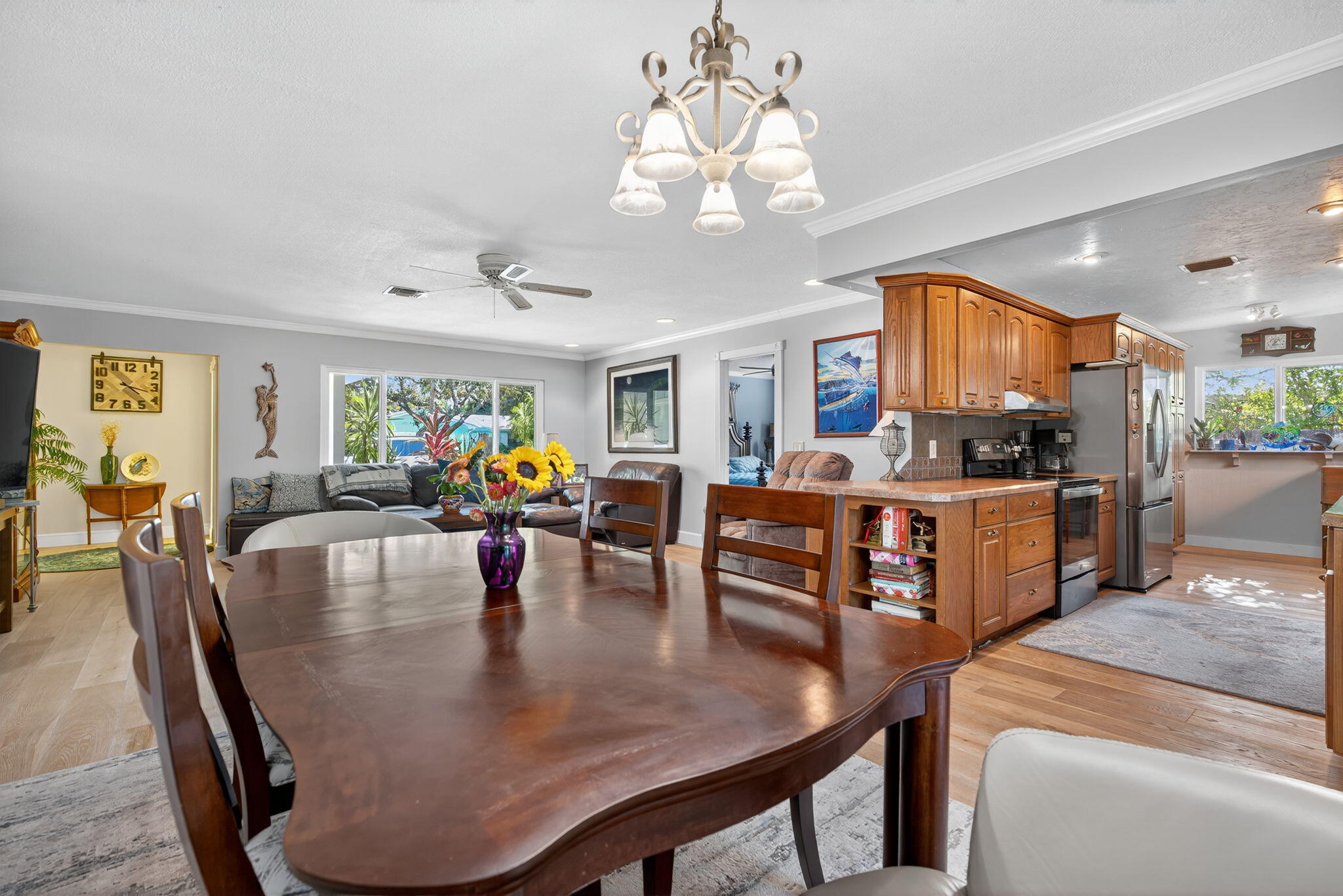 5095 Southeast Manatee Terrace Stuart, FL 34997 - Photo 17 of 58 a dining room filled chandelier and wooden floor