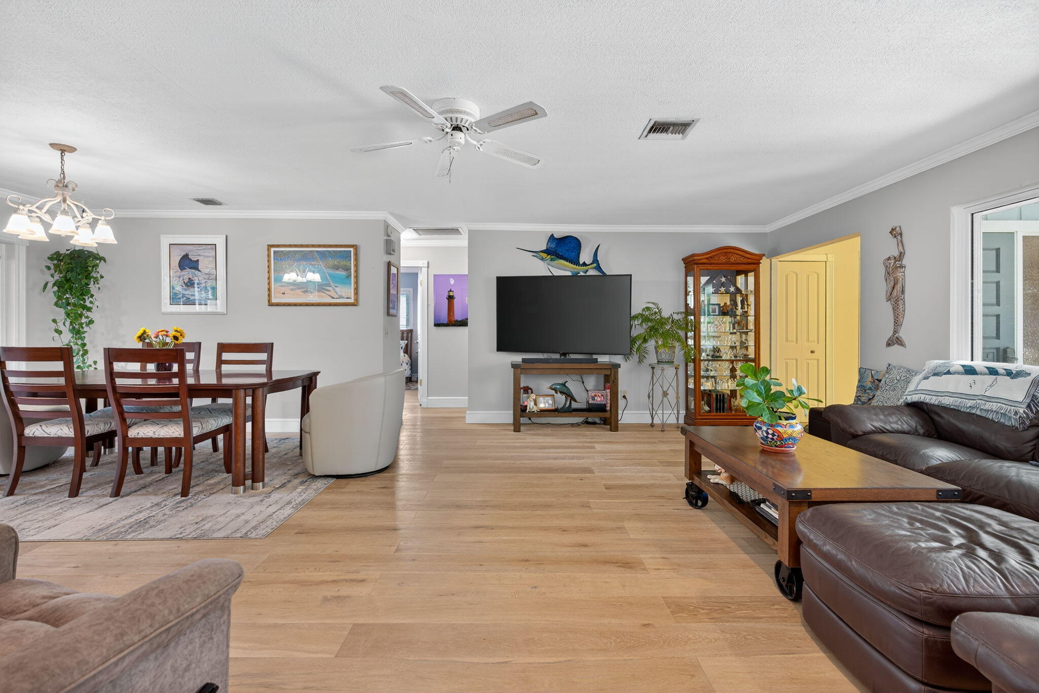 5095 Southeast Manatee Terrace Stuart, FL 34997 - Photo 3 of 58 a living room with furniture and a flat screen tv