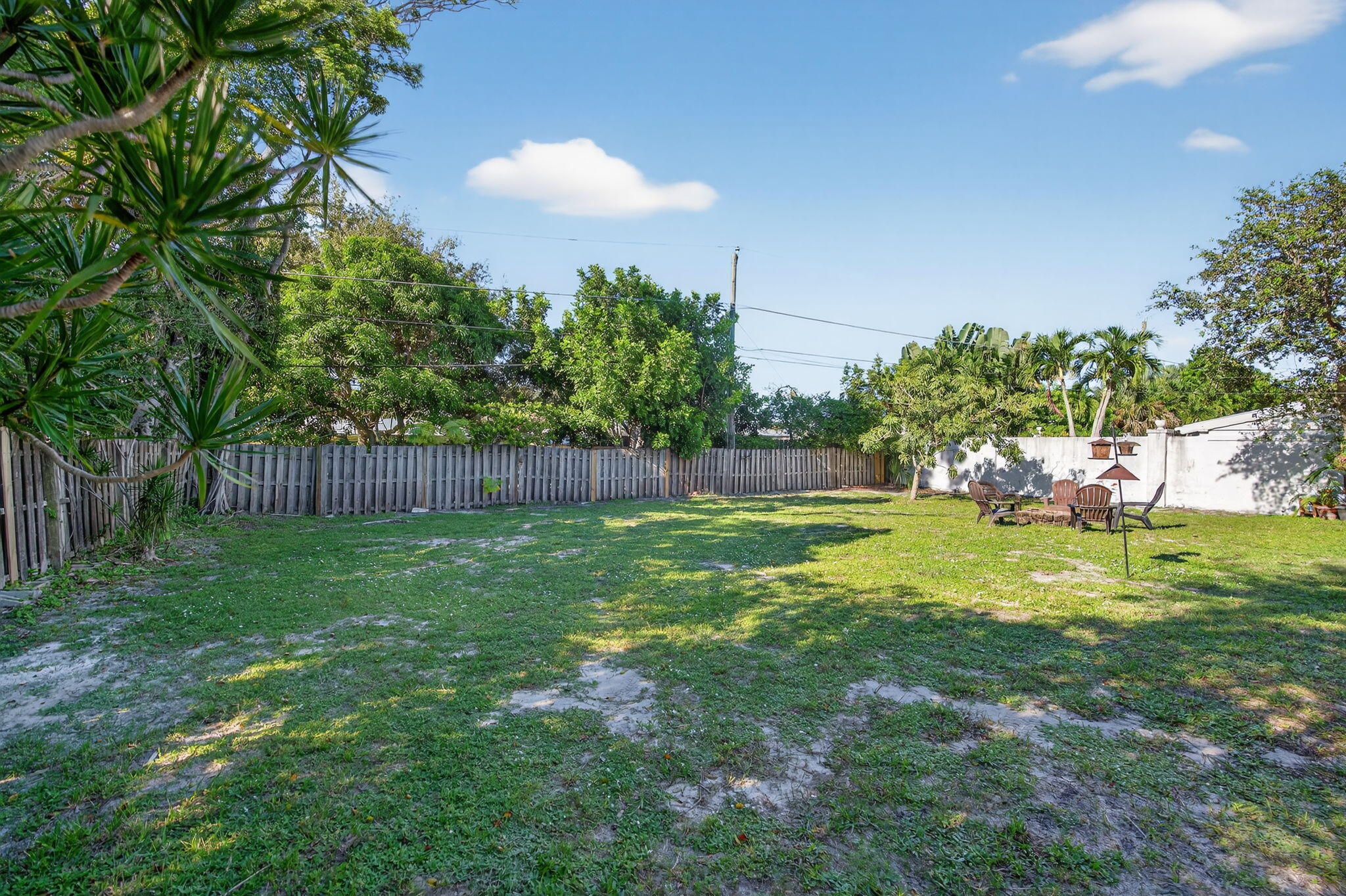 5095 Southeast Manatee Terrace Stuart, FL 34997 - Photo 39 of 58 a backyard of a house with lots of green space