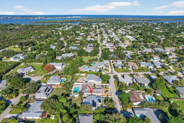 an aerial view of a house with a yard