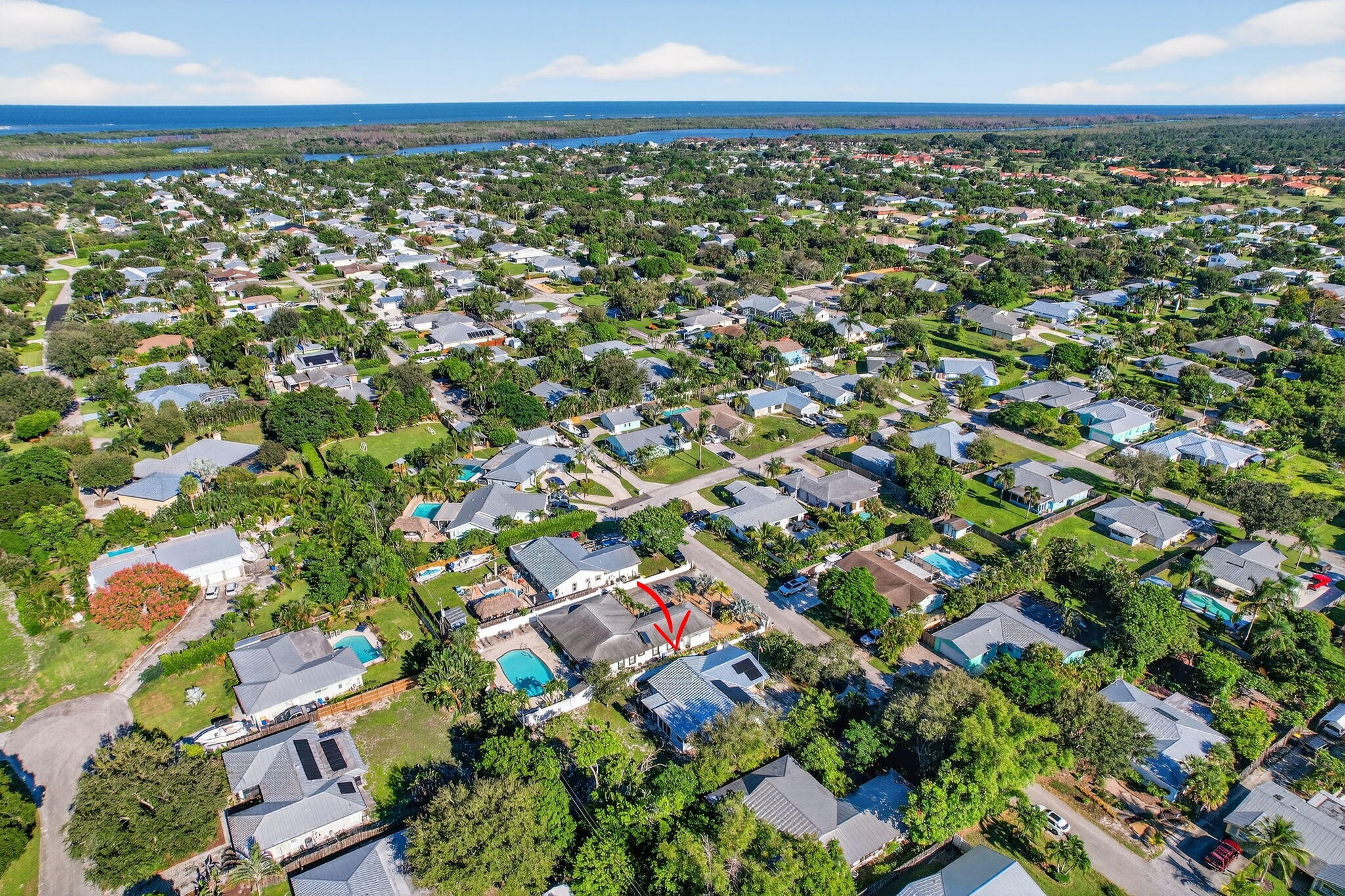 5095 Southeast Manatee Terrace Stuart, FL 34997 - Photo 44 of 58 an aerial view of residential houses with outdoor space and street view
