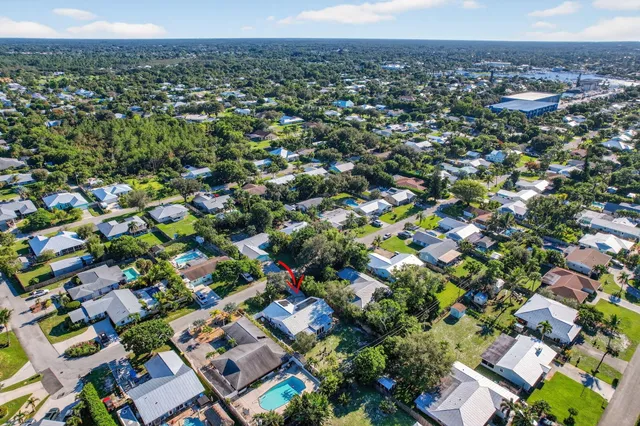 an aerial view of a house with a yard basket ball court and outdoor seating