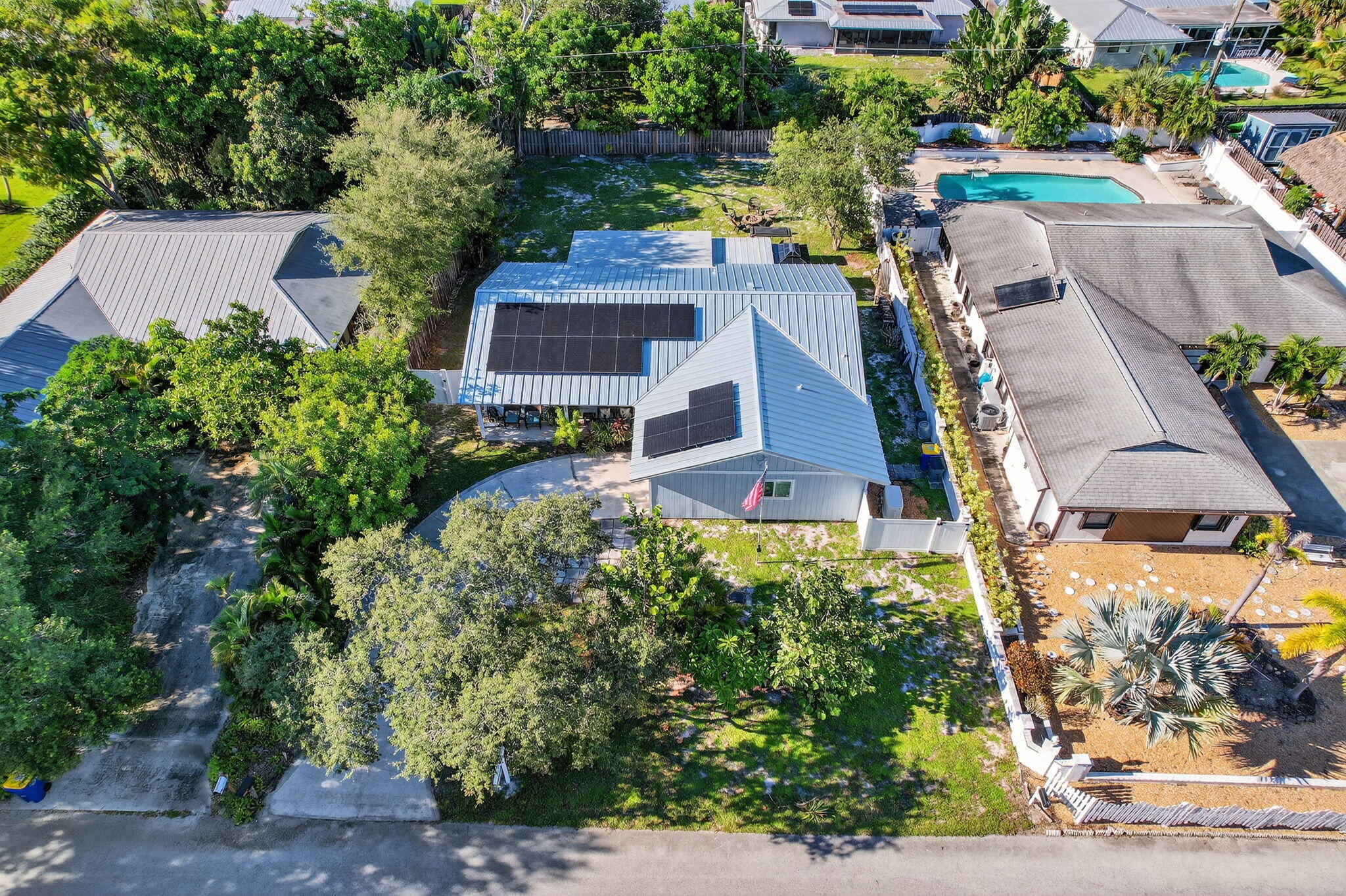 5095 Southeast Manatee Terrace Stuart, FL 34997 - Photo 53 of 58 an aerial view of a house with a yard basket ball court and outdoor seating