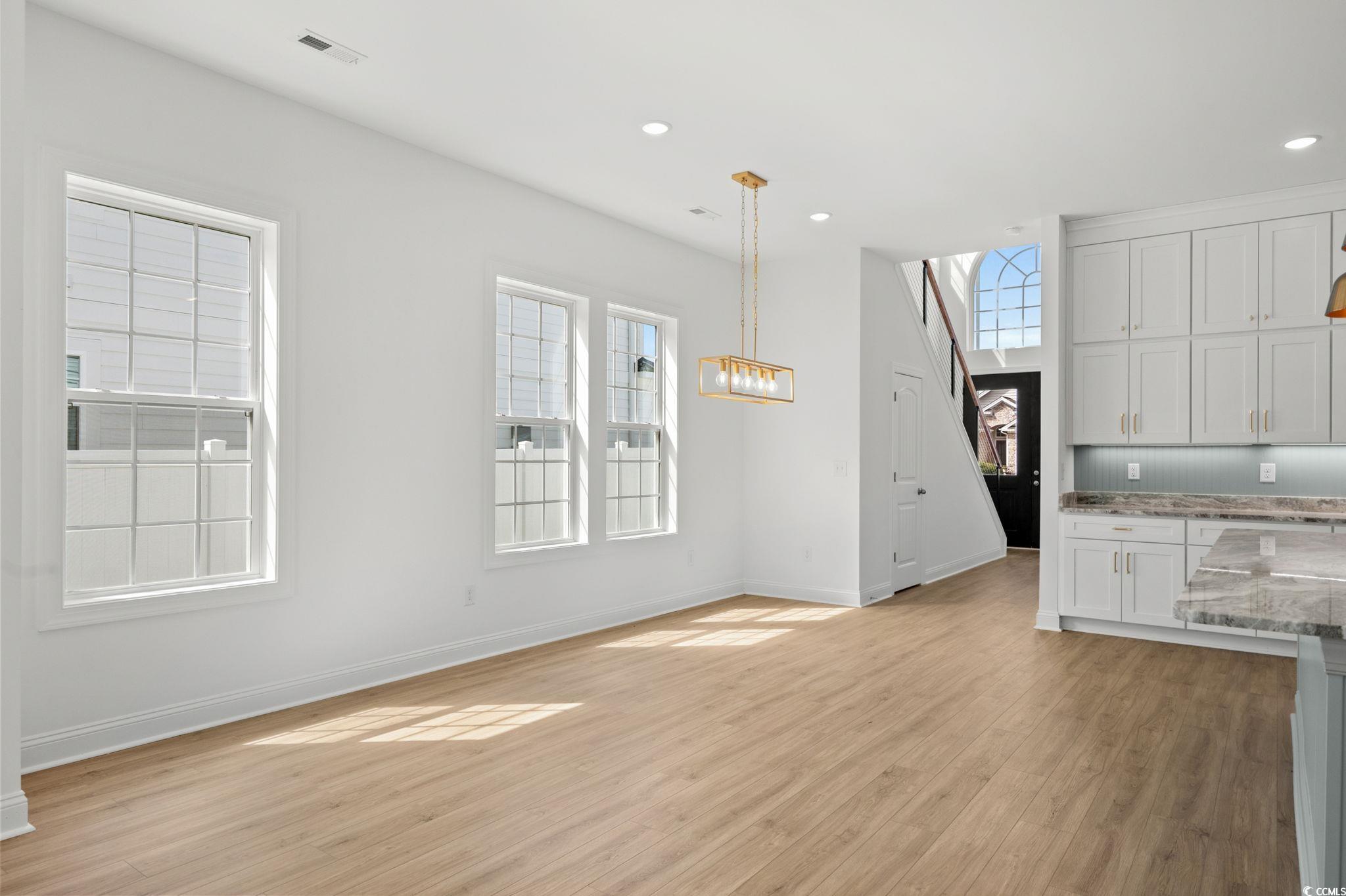 2247 Sand Dunes Drive Myrtle Beach, SC 29577 - Photo 12 of 40 Unfurnished living room with light wood-style flooring, recessed lighting, and a chandelier