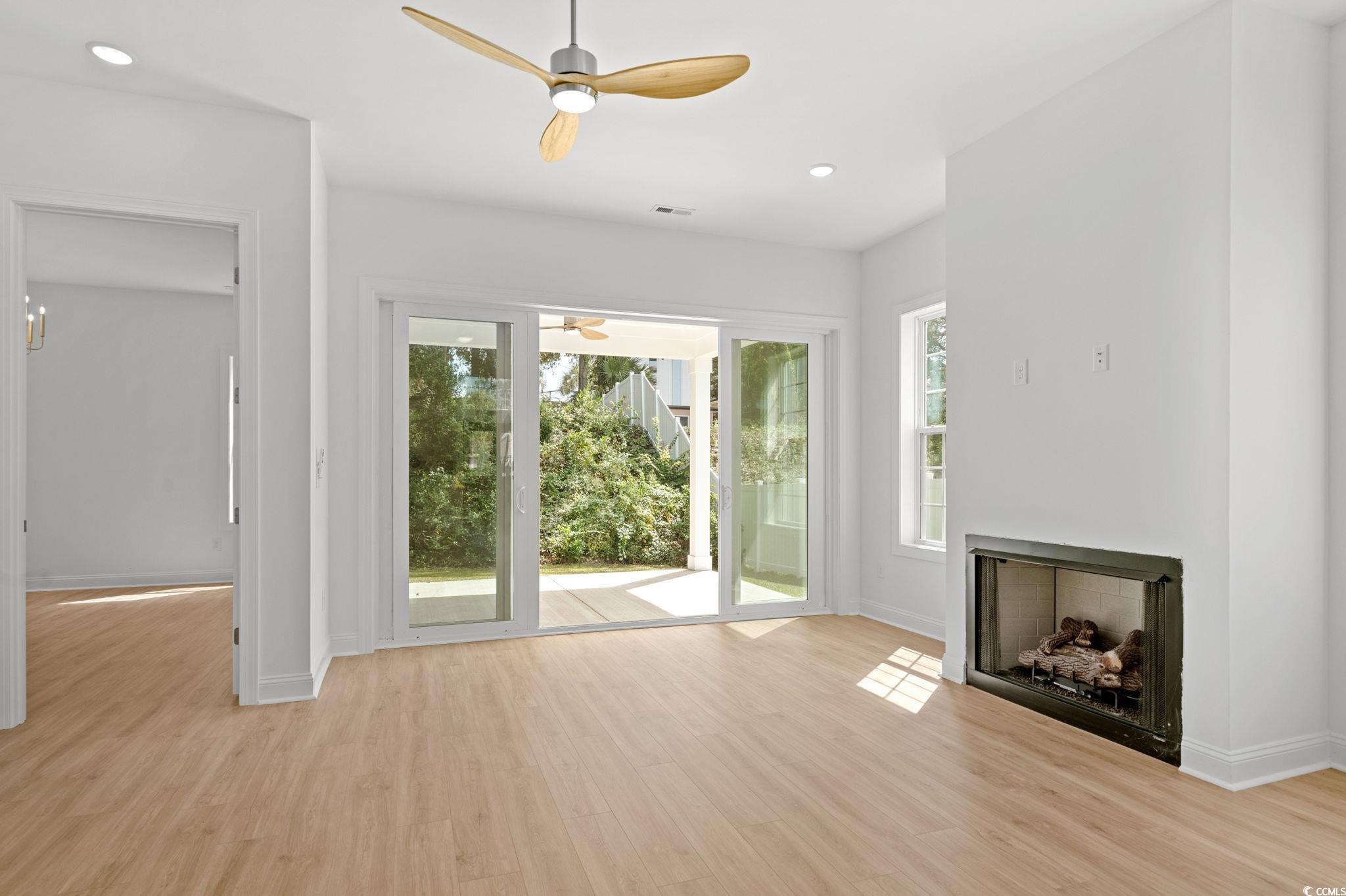 2247 Sand Dunes Drive Myrtle Beach, SC 29577 - Photo 15 of 40 Unfurnished living room featuring a ceiling fan, light wood finished floors, recessed lighting, and a fireplace