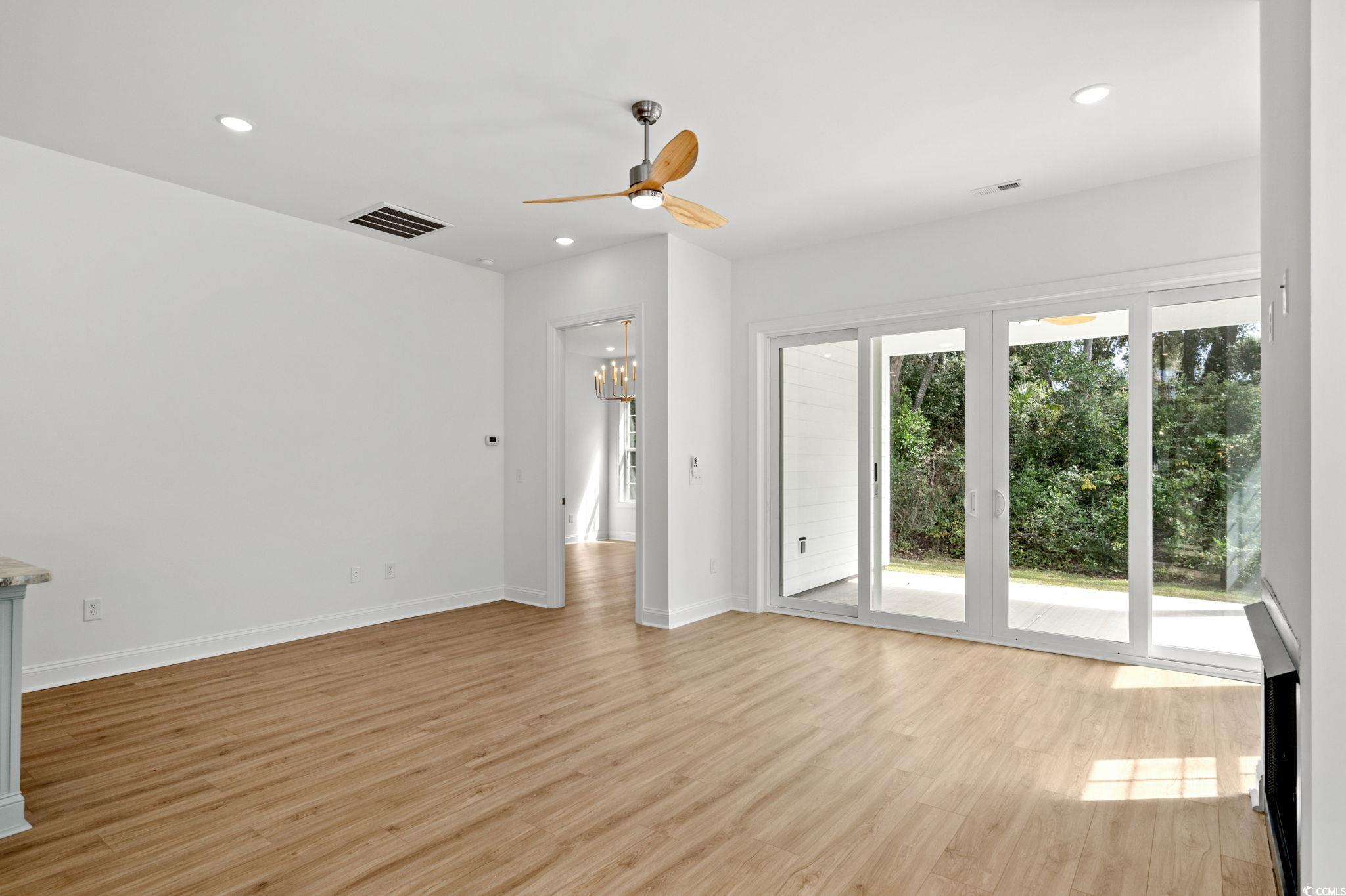 2247 Sand Dunes Drive Myrtle Beach, SC 29577 - Photo 16 of 40 Unfurnished living room featuring recessed lighting, light wood-type flooring, ceiling fan, and a chandelier