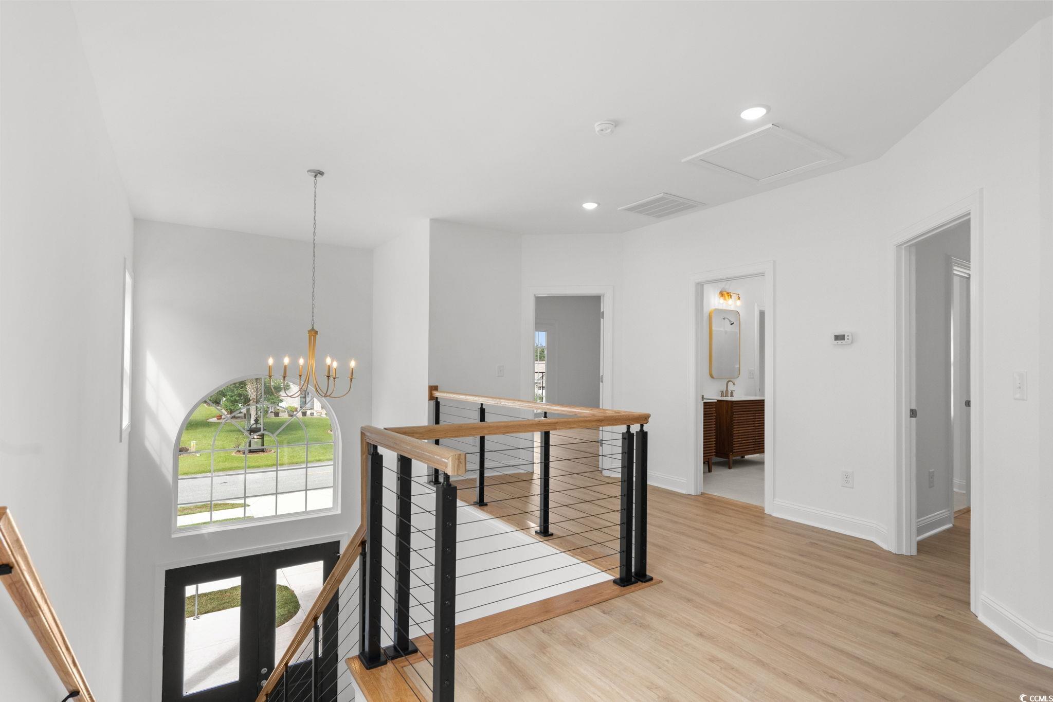 2247 Sand Dunes Drive Myrtle Beach, SC 29577 - Photo 20 of 40 Corridor featuring an upstairs landing, light wood-style flooring, a chandelier, and recessed lighting