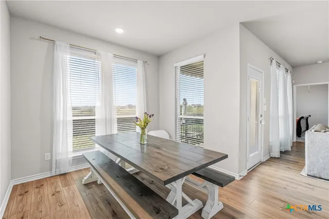 a view of a dining room with furniture and wooden floor