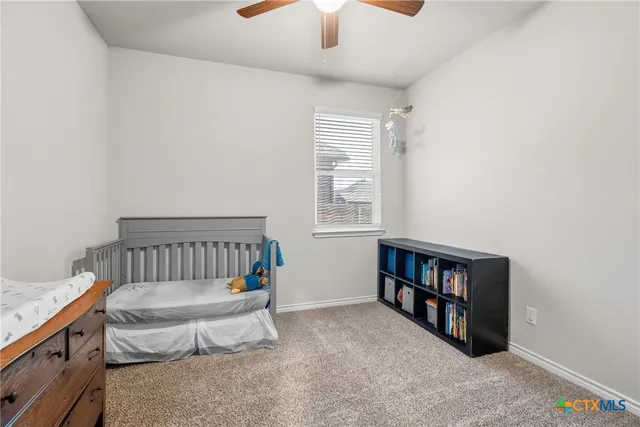 a bedroom with furniture and a book shelf