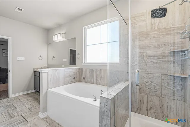 a bathroom with a bathtub and shower