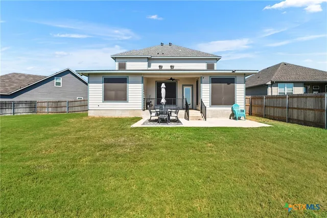 a view of a house with a backyard