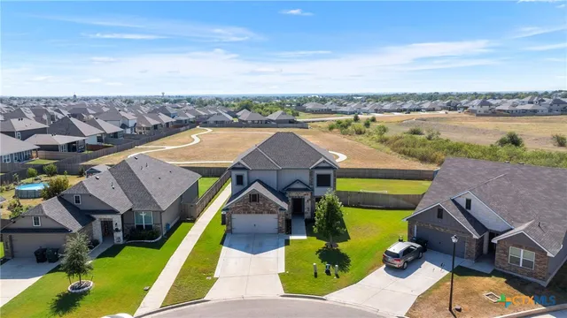 an aerial view of a house with a big yard
