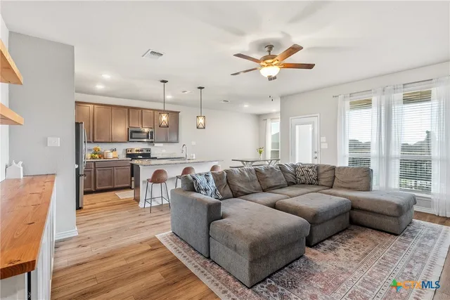 a living room with furniture and kitchen view