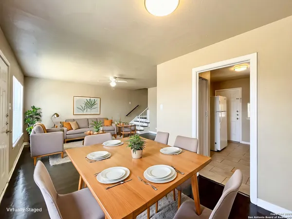 a dining room with furniture and wooden floor