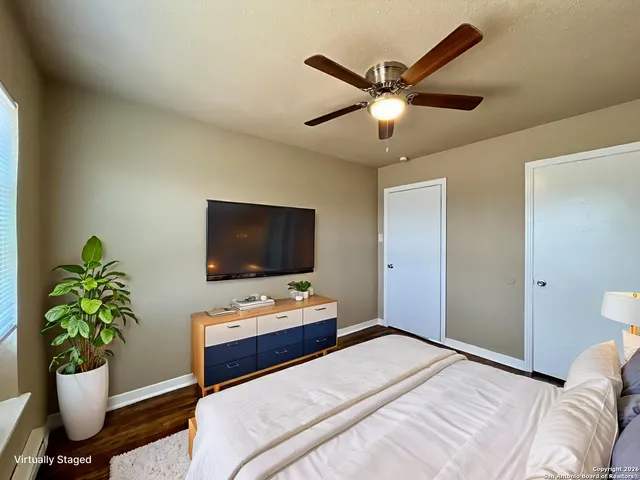 a bedroom with a bed and a potted plant