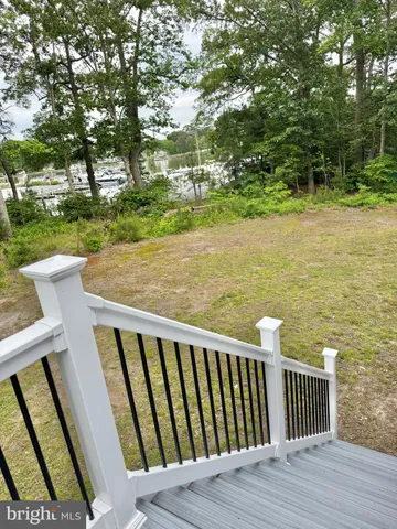 a view of a dining room with furniture a chandelier and wooden floor