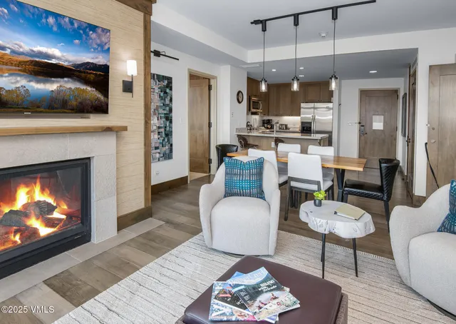 a living room with furniture and a view of kitchen