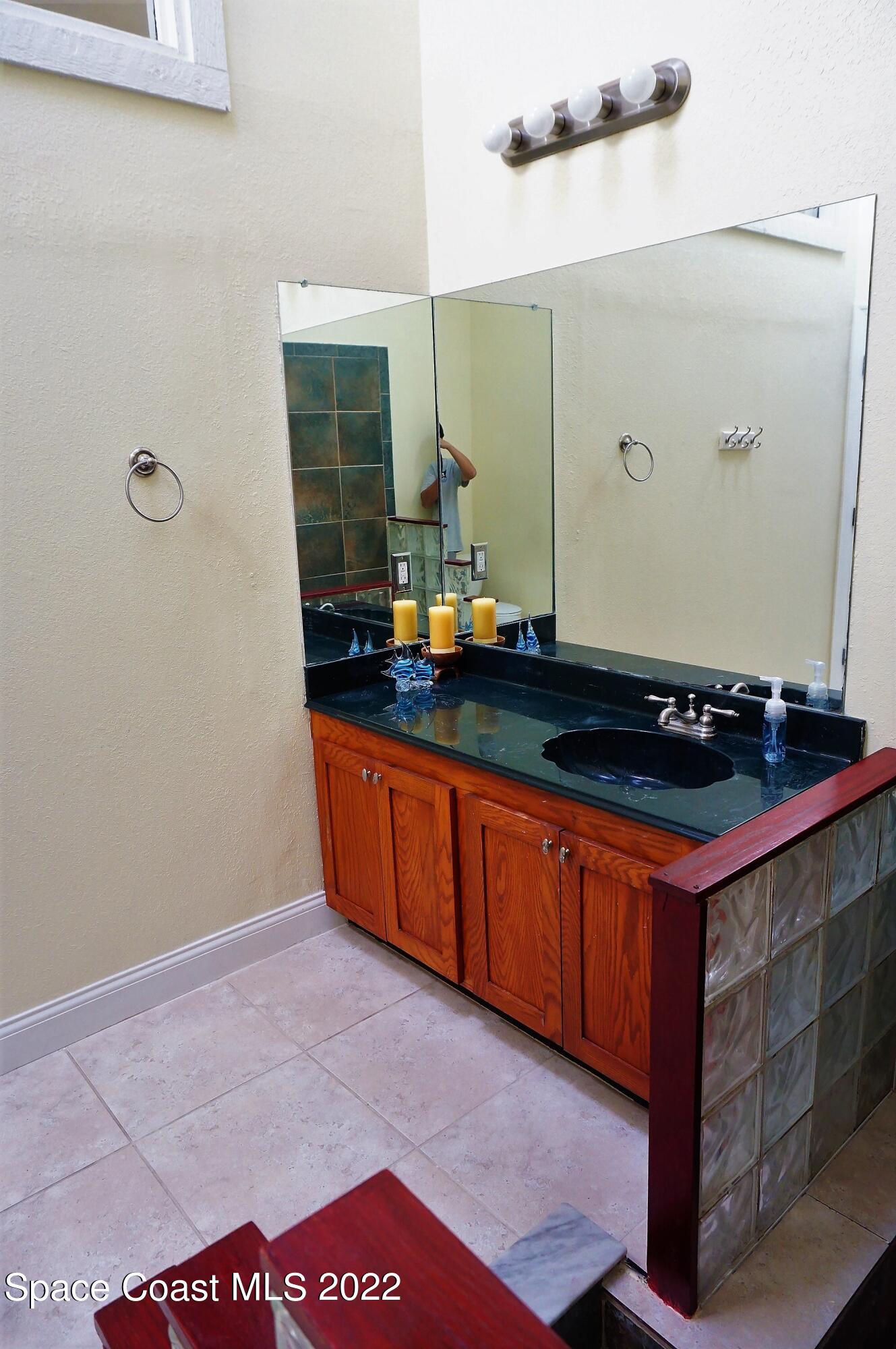 841 Preston Trail Melbourne, FL 32940 - Photo 16 of 20 a bathroom with a sink and a mirror