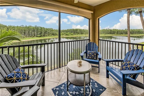 a view of a chair and tables in the balcony