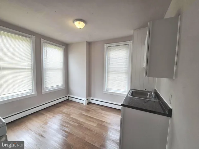 a kitchen with granite countertop a sink and a stove top oven