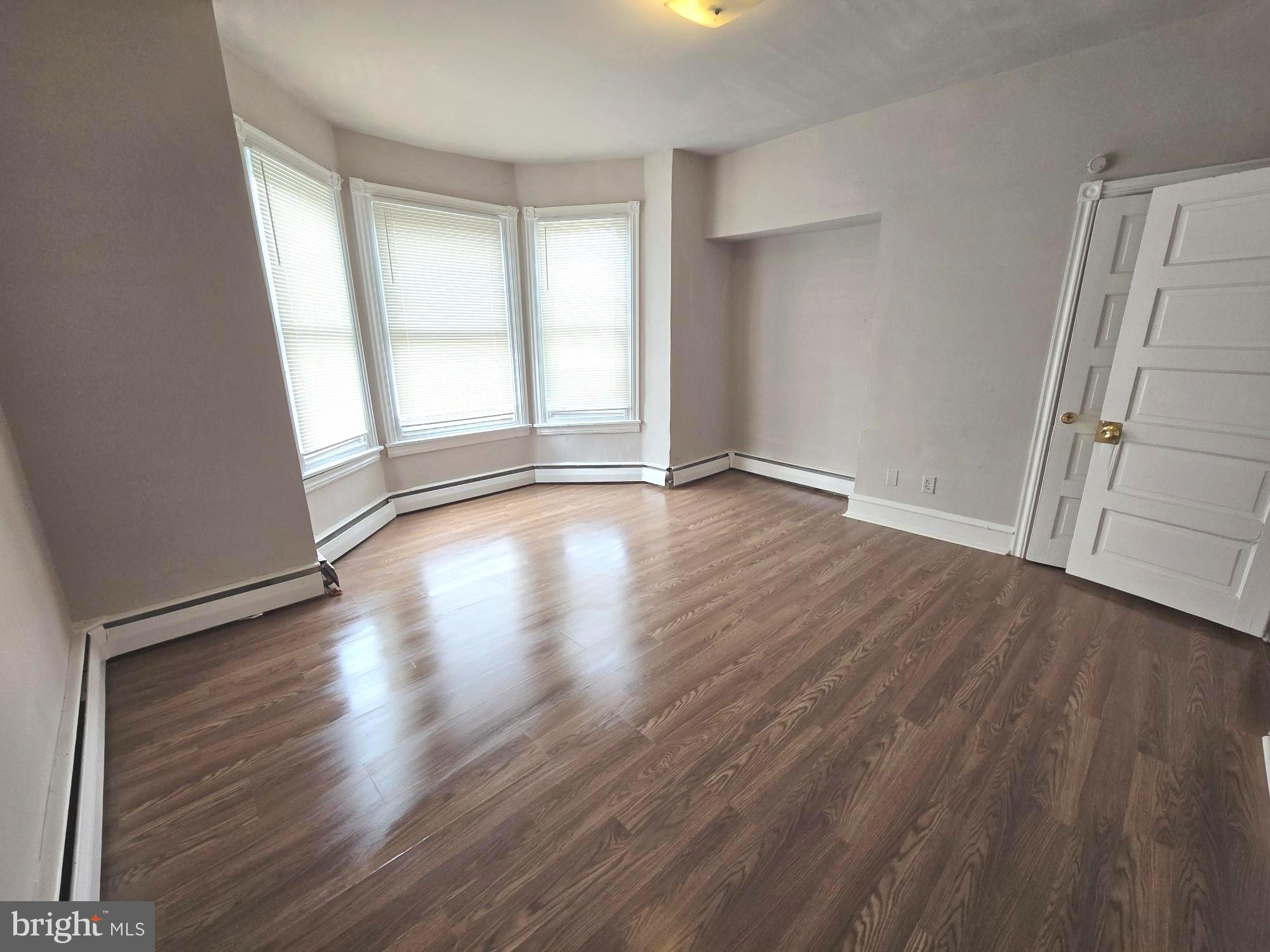 5709 Leonard Street Philadelphia, PA 19149 - Photo 13 of 19 an empty room with wooden floor and windows