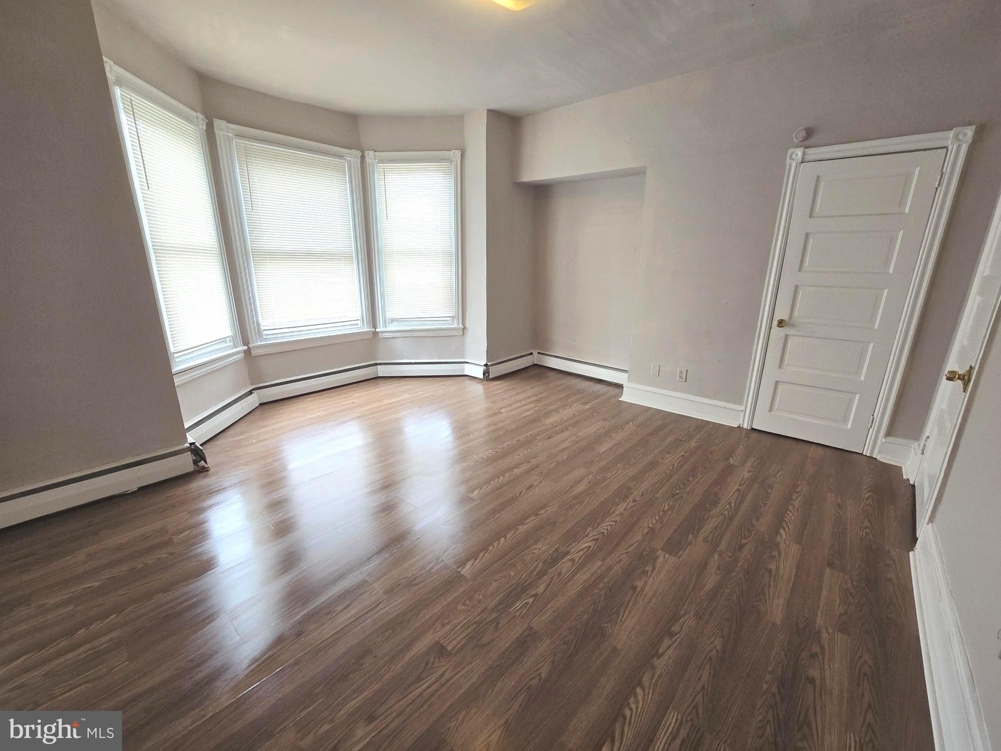 5709 Leonard Street Philadelphia, PA 19149 - Photo 14 of 19 an empty room with wooden floor and windows
