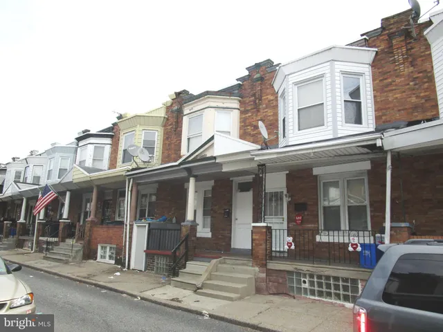 a view of a brick building next to a yard