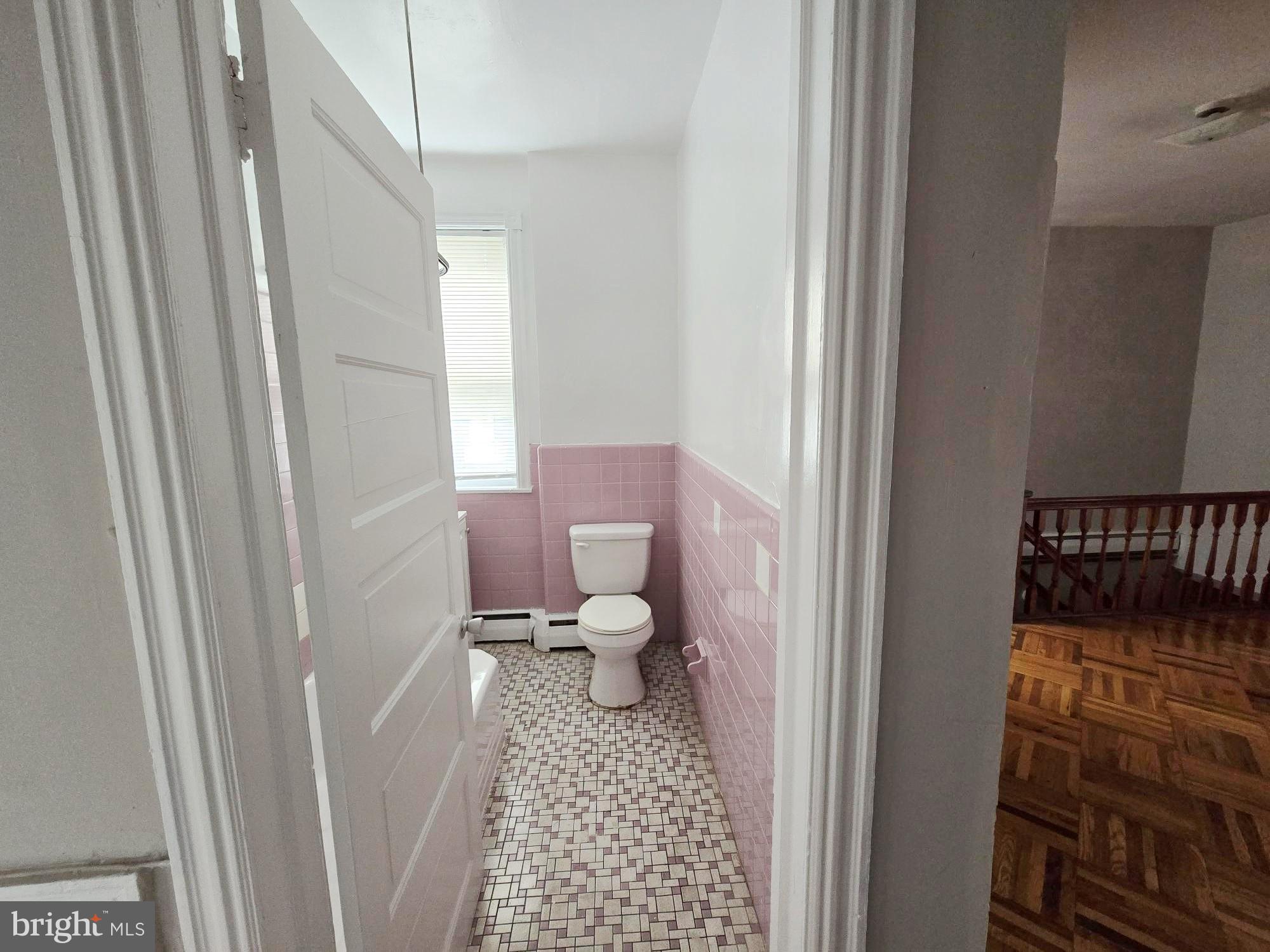 5709 Leonard Street Philadelphia, PA 19149 - Photo 5 of 19 a bathroom with a toilet and a shower curtain