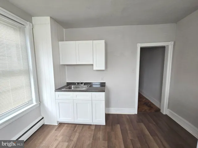 a kitchen with wooden floors and a stove