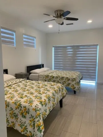 a bedroom with bed and window