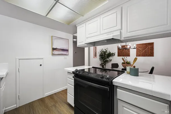 a kitchen with stainless steel appliances granite countertop a sink stove and cabinets
