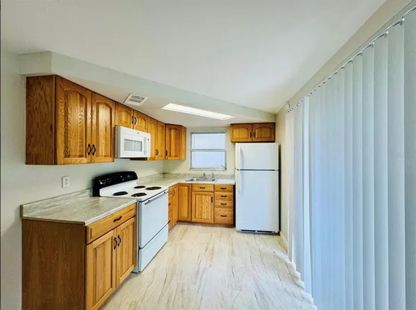 a kitchen with a stove a sink and a refrigerator