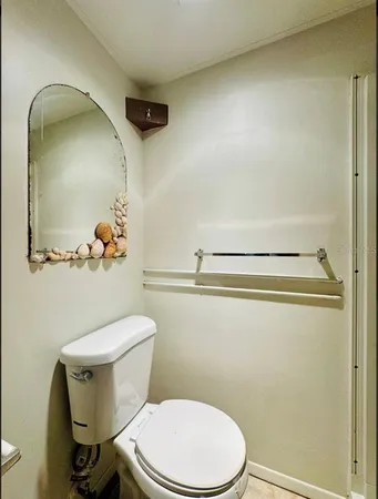 a white toilet sitting next to a bathroom sink