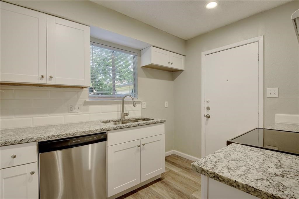 2311 Teri Road, Unit B Austin, TX 78744 - Photo 8 of 25 a kitchen with a sink and cabinets