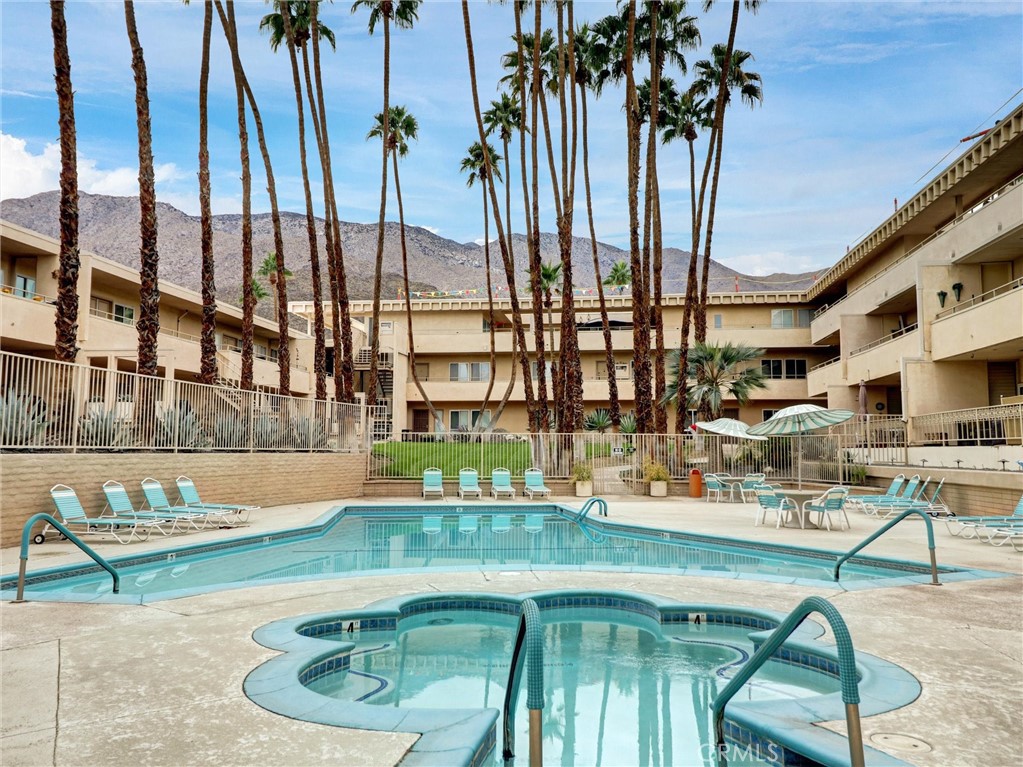 277 East Alejo Road, Unit 214 Palm Springs, CA 92262 - Photo 11 of 17 a view of swimming pool with a couches and chairs