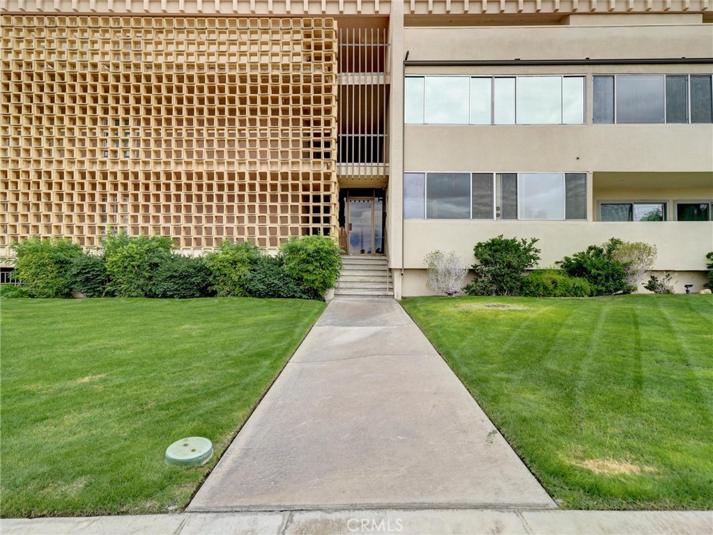 277 East Alejo Road, Unit 214 Palm Springs, CA 92262 - Photo 17 of 17 a front view of a building with garden