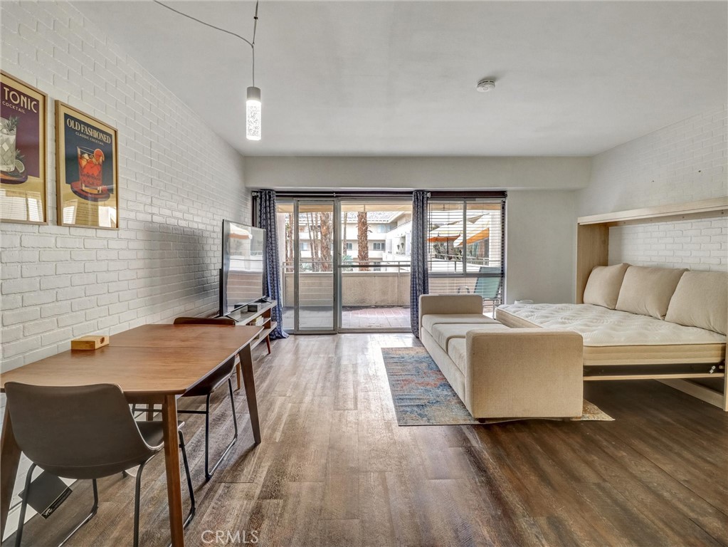 277 East Alejo Road, Unit 214 Palm Springs, CA 92262 - Photo 4 of 17 a living room with furniture and wooden floor