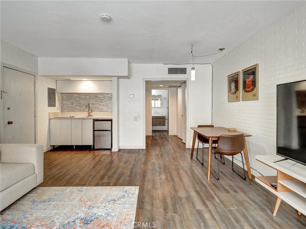 277 East Alejo Road, Unit 214 Palm Springs, CA 92262 - Photo 5 of 17 a living room with furniture and a wooden floor