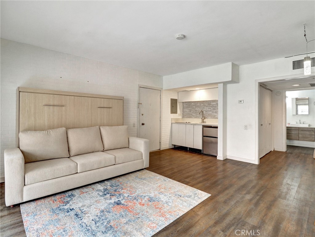 277 East Alejo Road, Unit 214 Palm Springs, CA 92262 - Photo 6 of 17 a living room with furniture and kitchen view