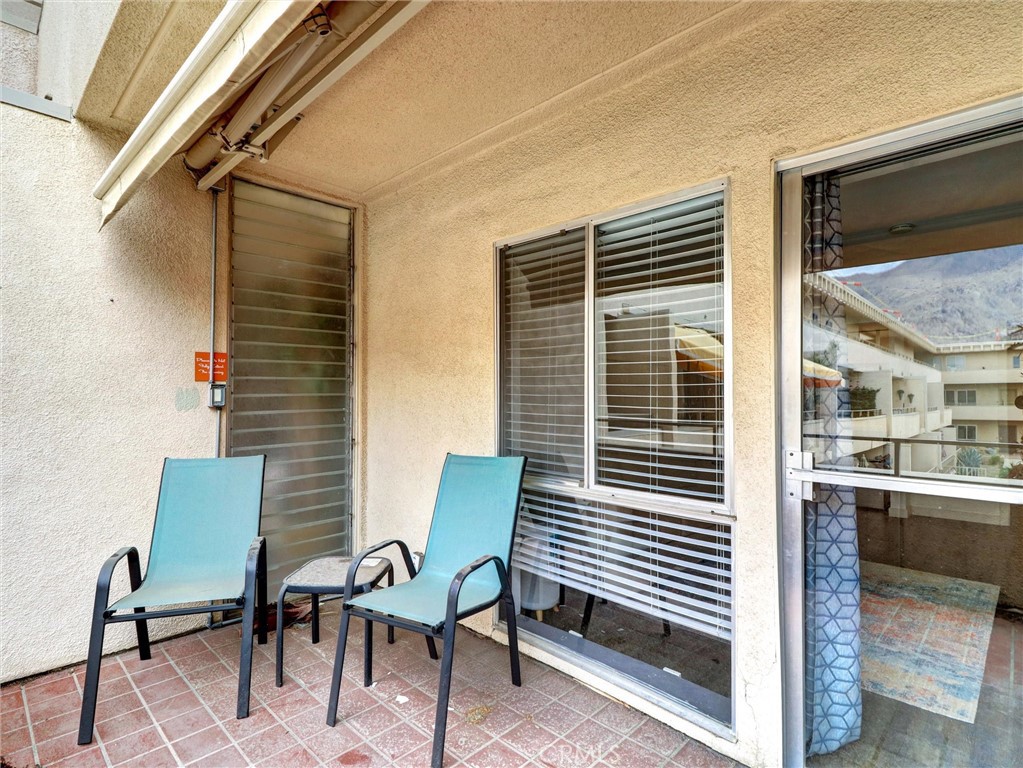 277 East Alejo Road, Unit 214 Palm Springs, CA 92262 - Photo 10 of 17 a balcony with table and chairs