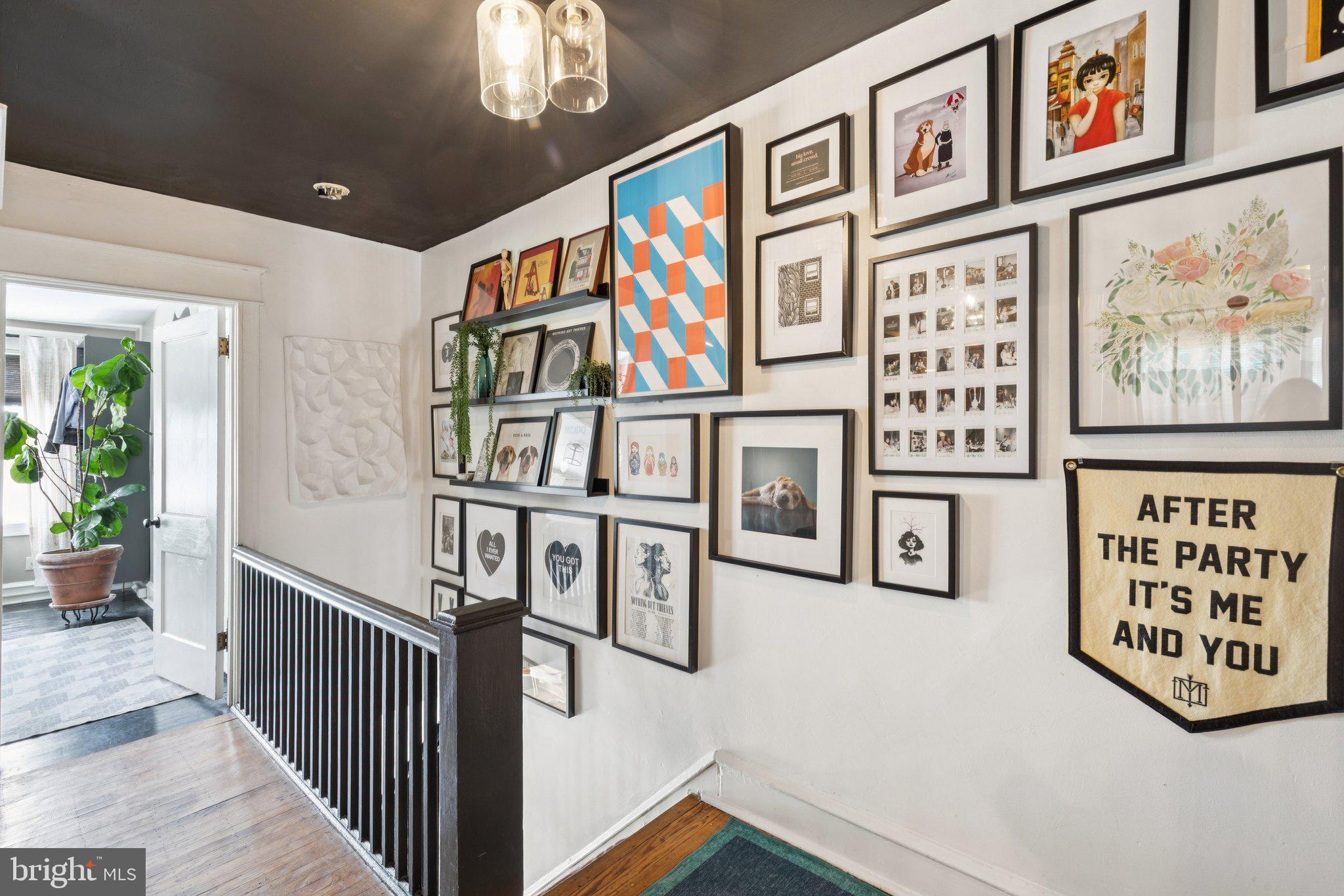 674 Wendover Street Philadelphia, PA 19128 - Photo 25 of 50 Gallery-style hallway with vibrant art.