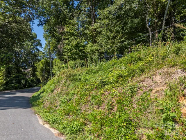 an aerial view of a houses with a yard