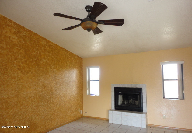 306 Camino La Pasida Rio Rico, AZ 85648 - Photo 3 of 10 a view of a livingroom with a fireplace and window